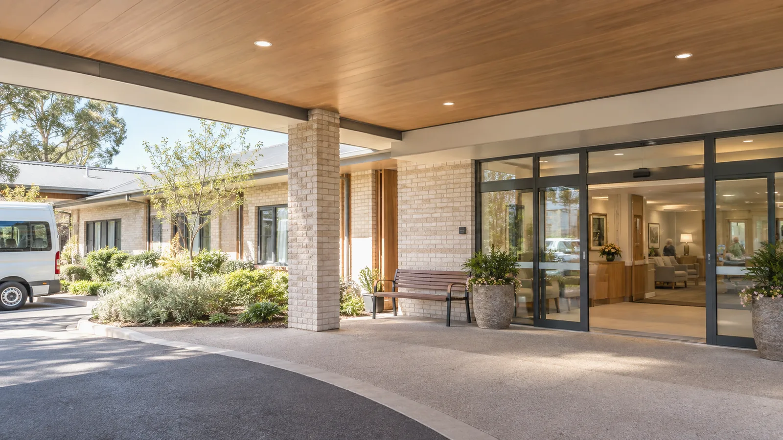 The covered entrance and garden seating of a modern Australian aged care facility