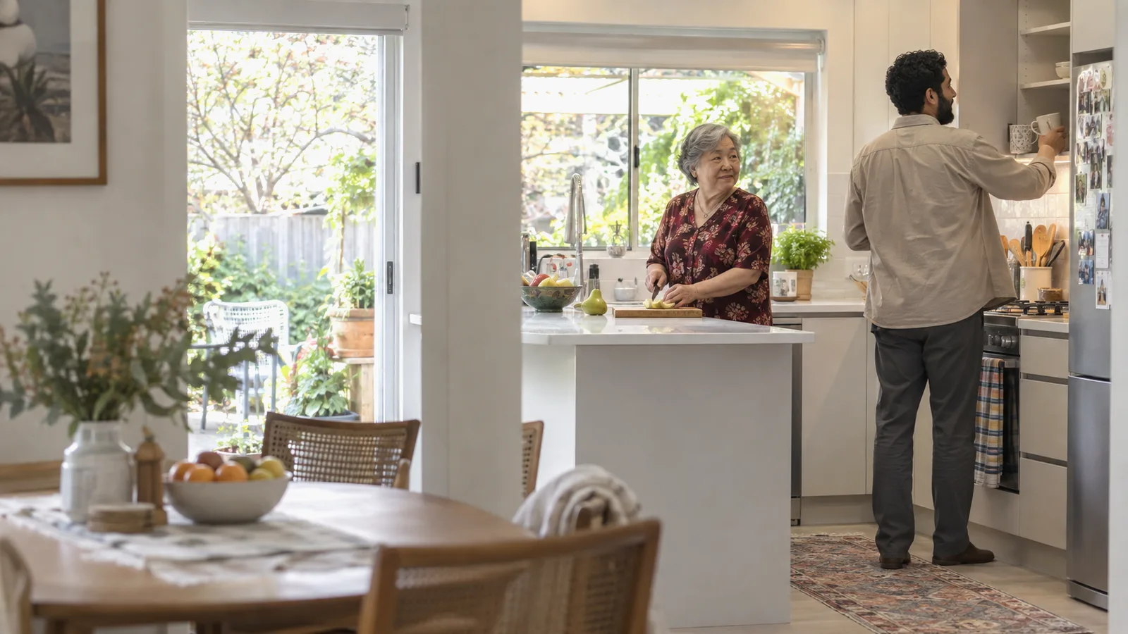A home care worker cooking with an older woman in her kitchen